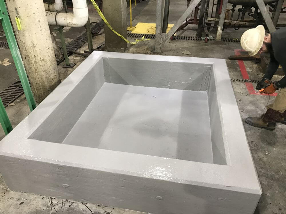 Secondary containment1 Worker applying protective coating to secondary containment structure
